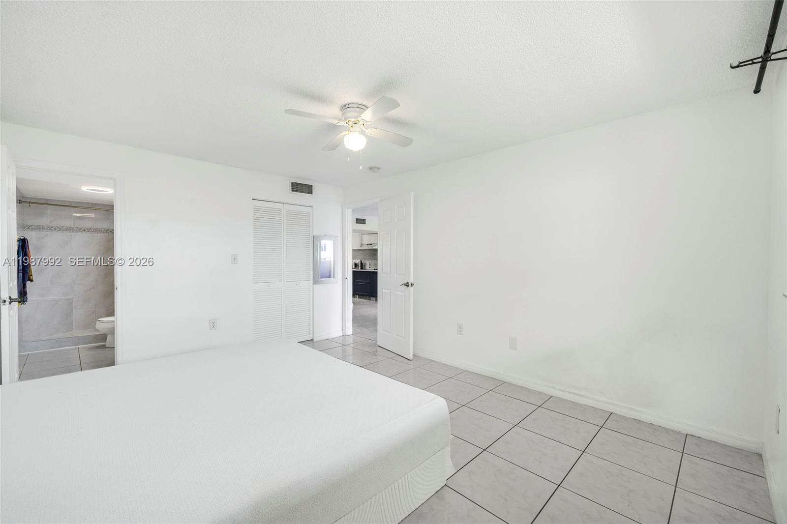 18001 North Bay Road, Unit 505 Sunny Isles Beach, FL 33160 - Photo 13 of 16 a bedroom with a bed and a ceiling fan