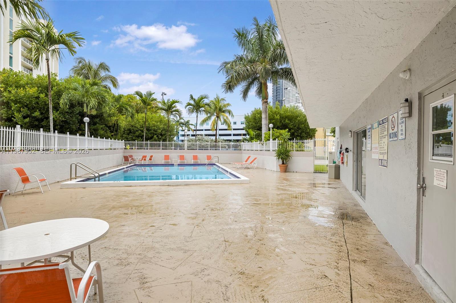 18001 North Bay Road, Unit 505 Sunny Isles Beach, FL 33160 - Photo 16 of 16 a view of a swimming pool with a patio and a yard