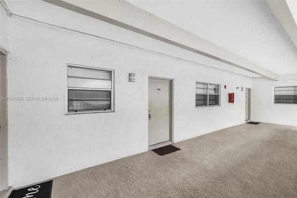 a view of a livingroom with an empty space and a window