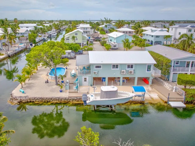 an aerial view of a house with a swimming pool yard and outdoor seating