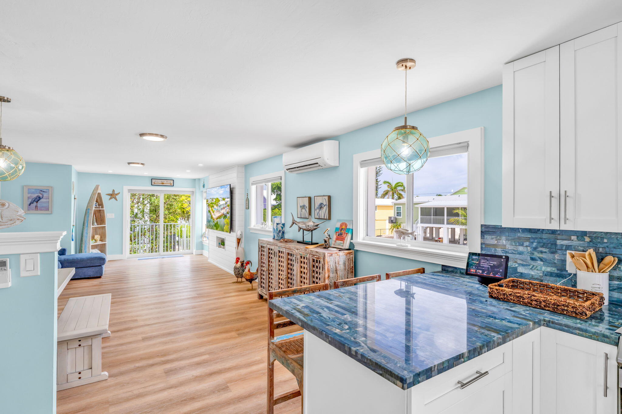28538 John Silver Road Summerland Key, FL 33042 - Photo 14 of 45 a kitchen with stainless steel appliances granite countertop a stove top oven a sink dishwasher a dining table and chairs with wooden floor