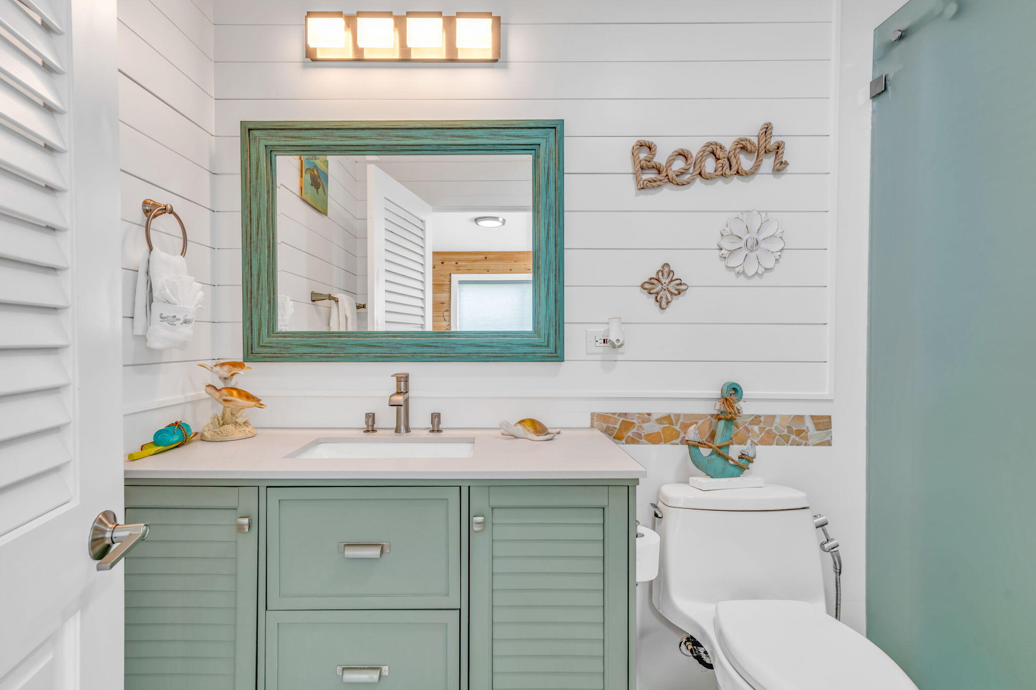 28538 John Silver Road Summerland Key, FL 33042 - Photo 23 of 45 a bathroom with a sink toilet vanity and mirror