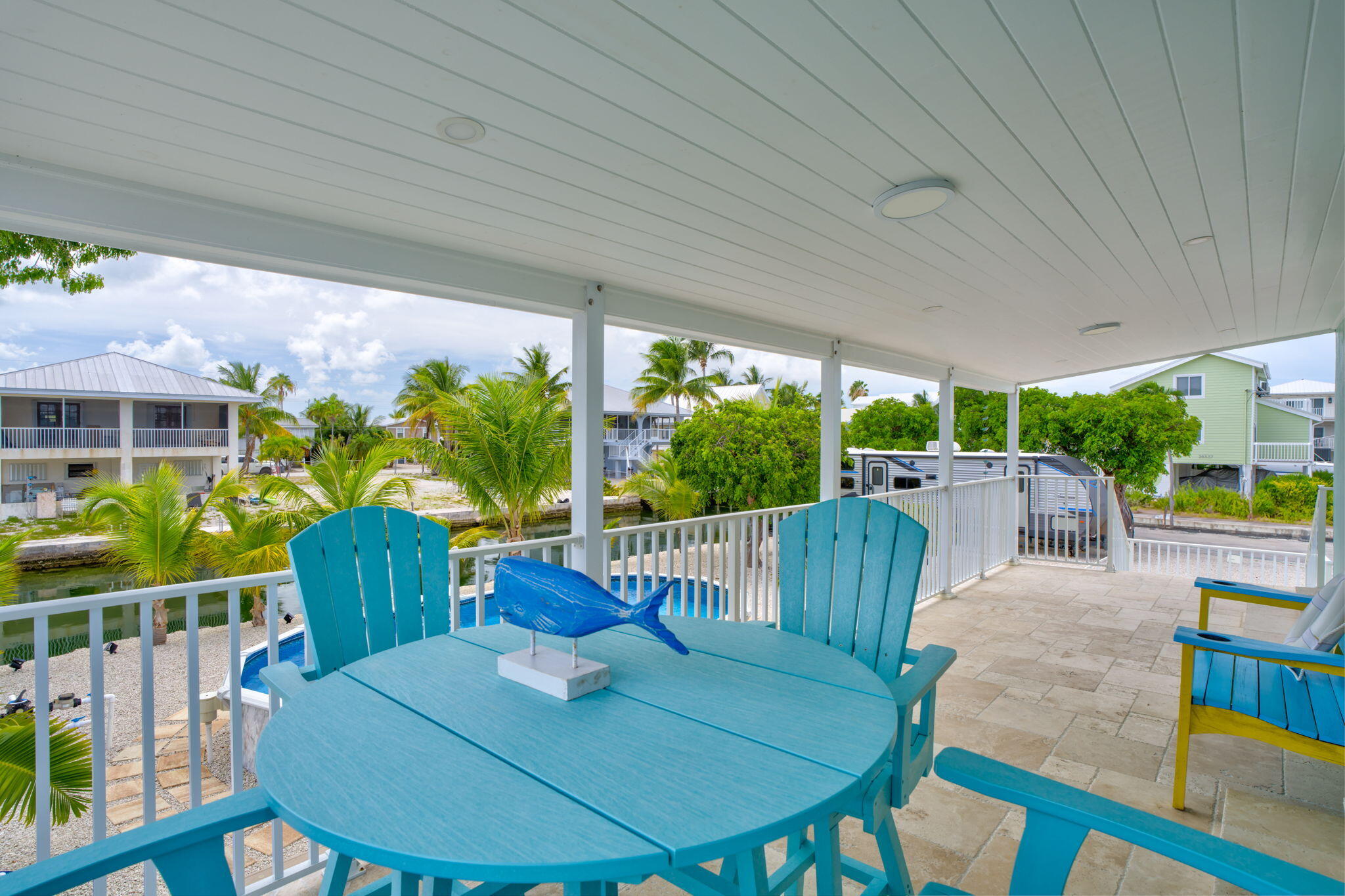 28538 John Silver Road Summerland Key, FL 33042 - Photo 27 of 45 a view of a patio with a table chairs and a backyard