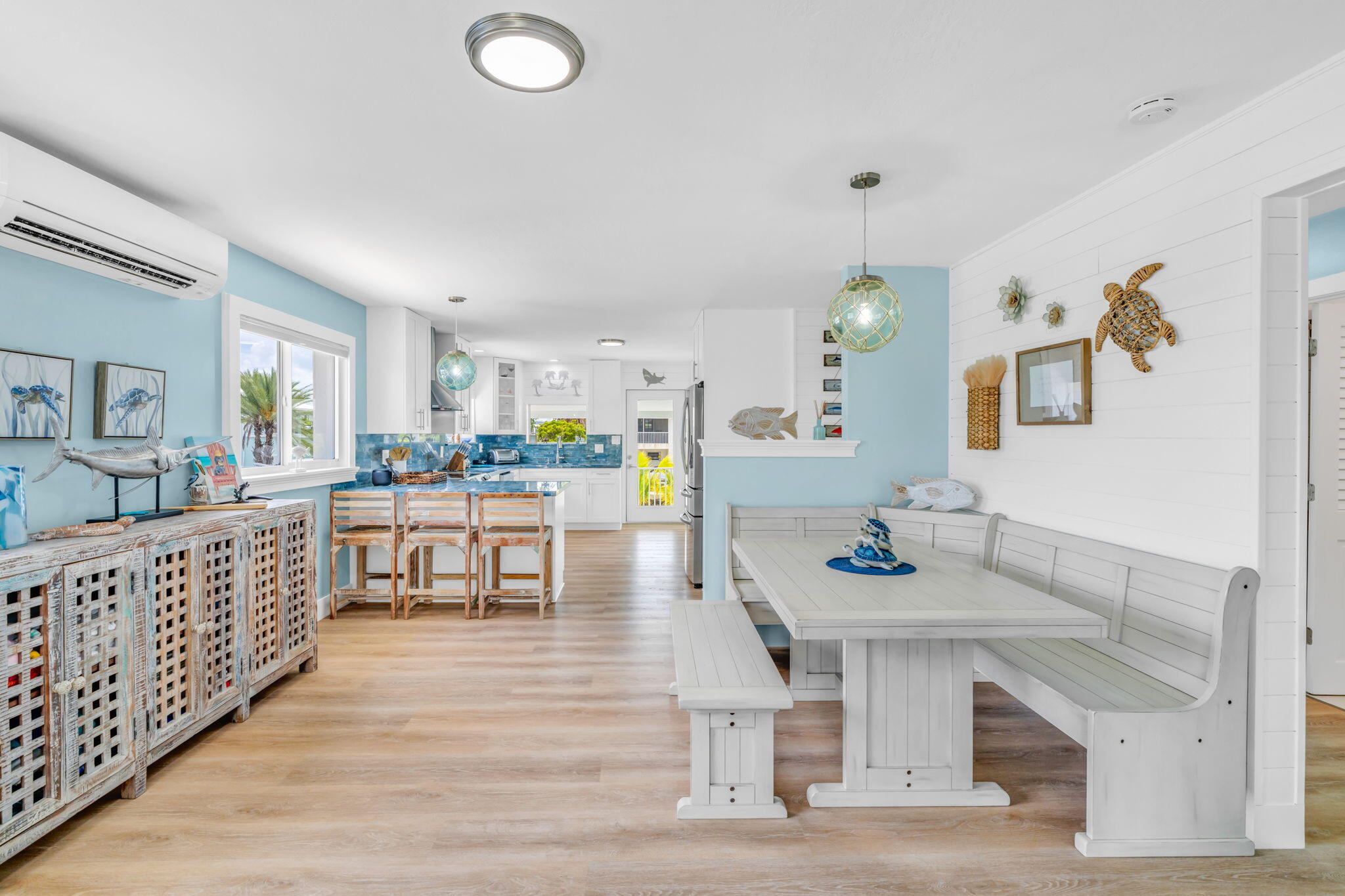 28538 John Silver Road Summerland Key, FL 33042 - Photo 6 of 45 a kitchen with white cabinets and chairs