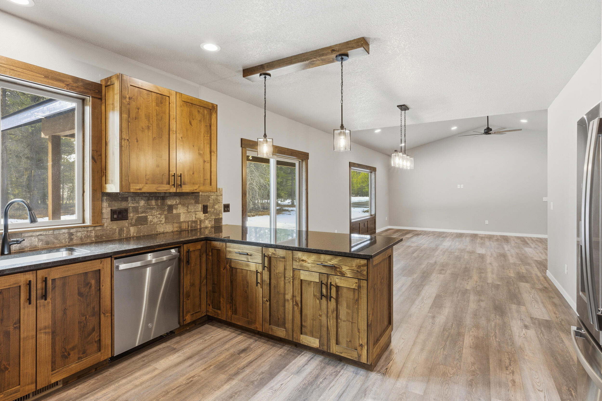 16083 Dyke Road, Unit 9 La Pine, OR 97739 - Photo 12 of 53 a large kitchen with a sink and wooden floor
