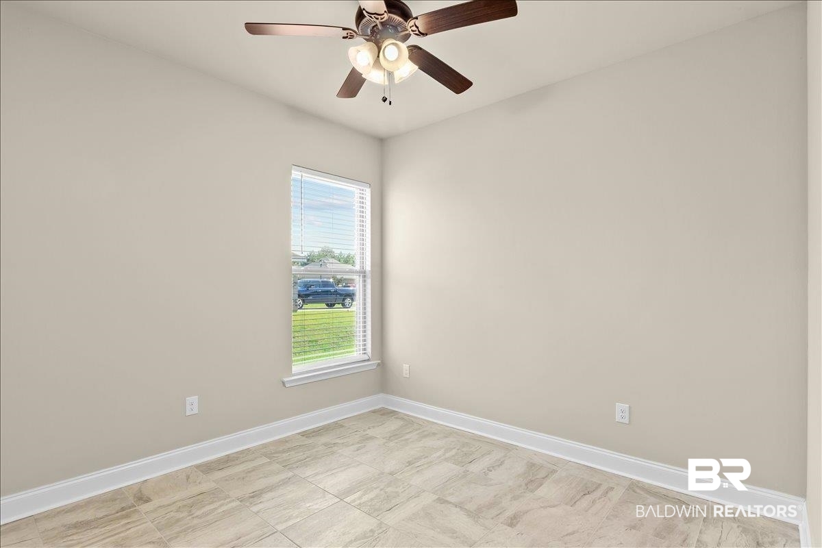 1112 Stella Road Foley, AL 36535 - Photo 18 of 33 Spare room featuring baseboards and ceiling fan