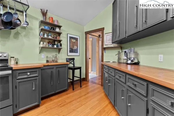 a kitchen with a sink a stove and cabinets