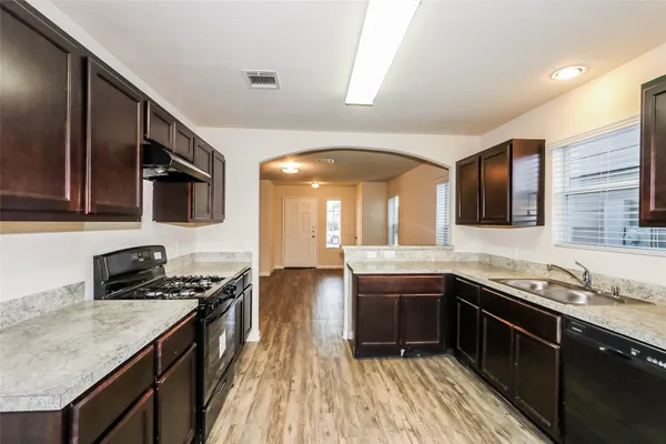 a kitchen with stainless steel appliances granite countertop counter space a sink and cabinets