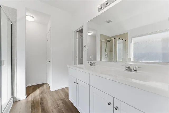 a spacious bathroom with a double vanity sink and mirror