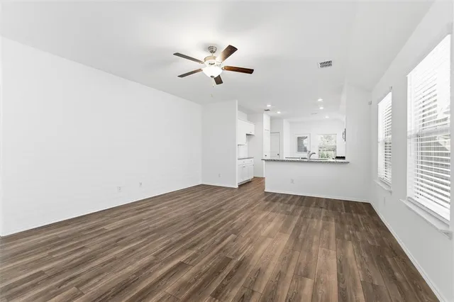 a view of a kitchen with wooden floor and a kitchen
