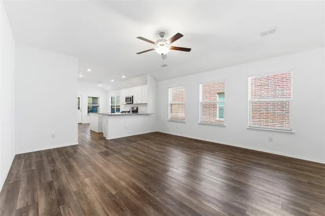 a view of a kitchen with wooden floor and a kitchen