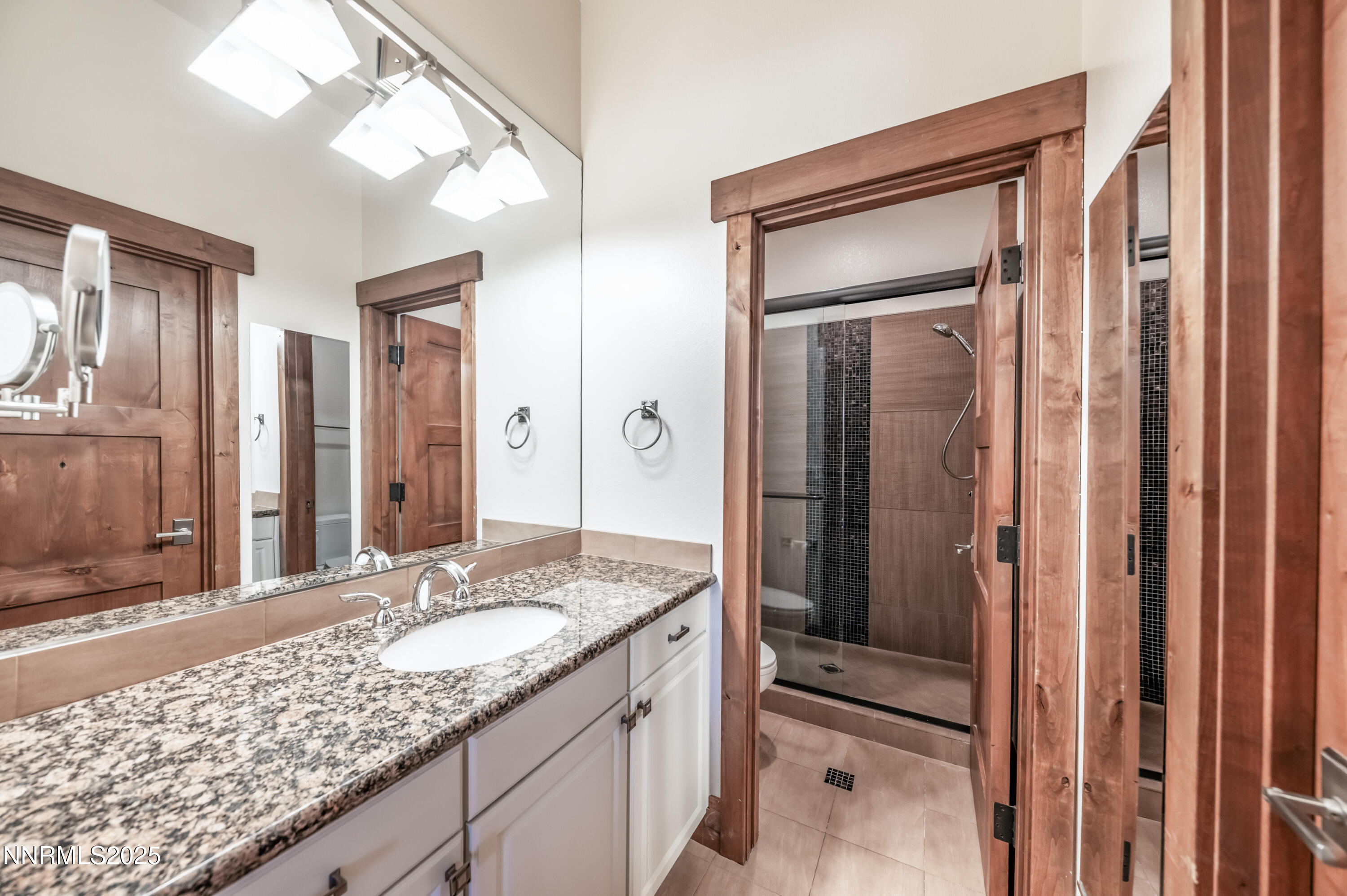 2195 Candle Rock Court Reno, NV 89523 - Photo 24 of 29 a bathroom with a granite countertop sink and a mirror