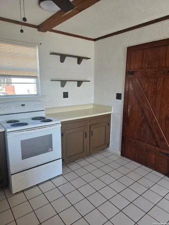 a kitchen with a white cabinets and white appliances