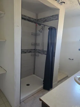 a bathroom with a glass shower door