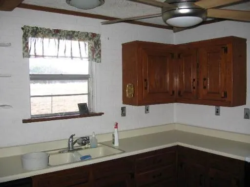 a kitchen with a sink cabinets and window