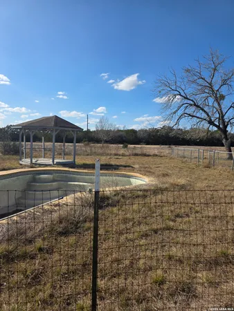 a view of swimming pool with outdoor seating and yard in back