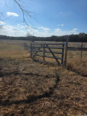 a view of dirt yard with a tree