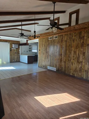 a view of a kitchen with a sink and wooden floor