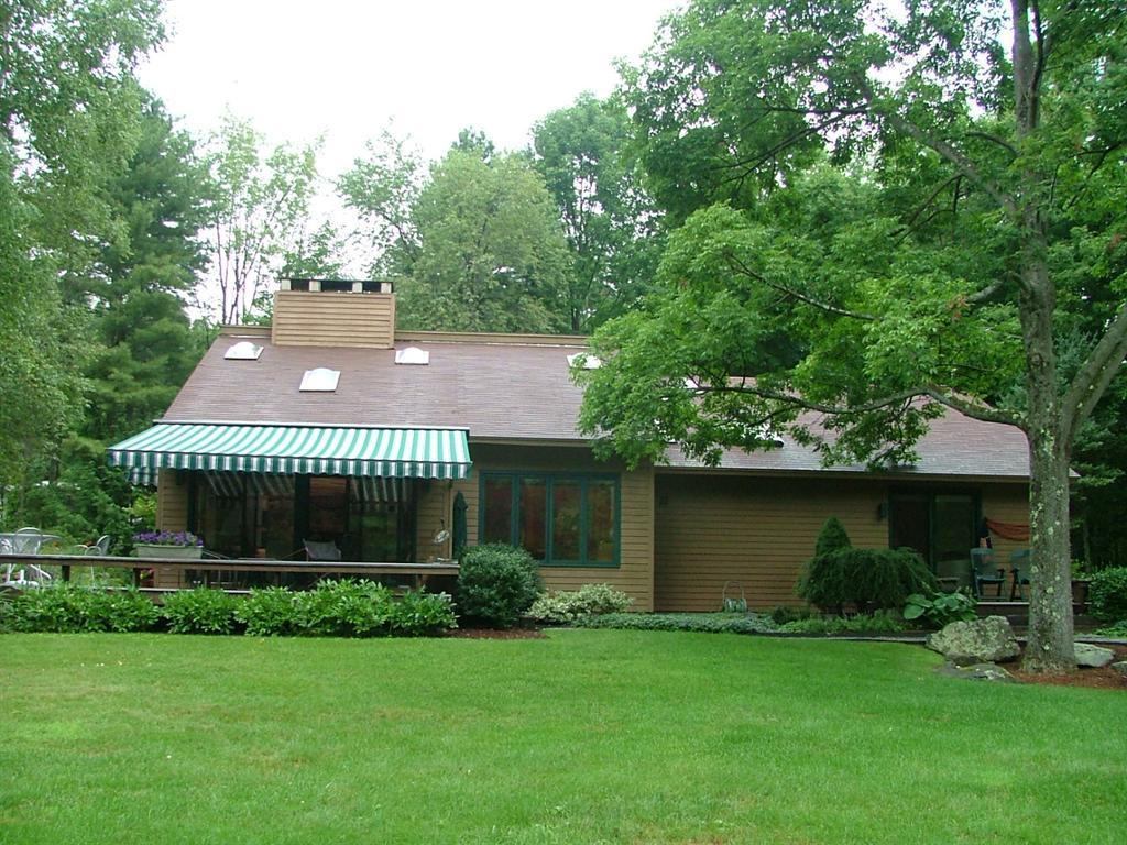 7 Old Tree Farm Road Stockbridge, MA 01266 - Photo 4 of 21 a front view of a house with a yard and garage