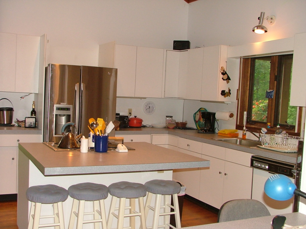 7 Old Tree Farm Road Stockbridge, MA 01266 - Photo 6 of 21 a kitchen with a dining table chairs and white appliances