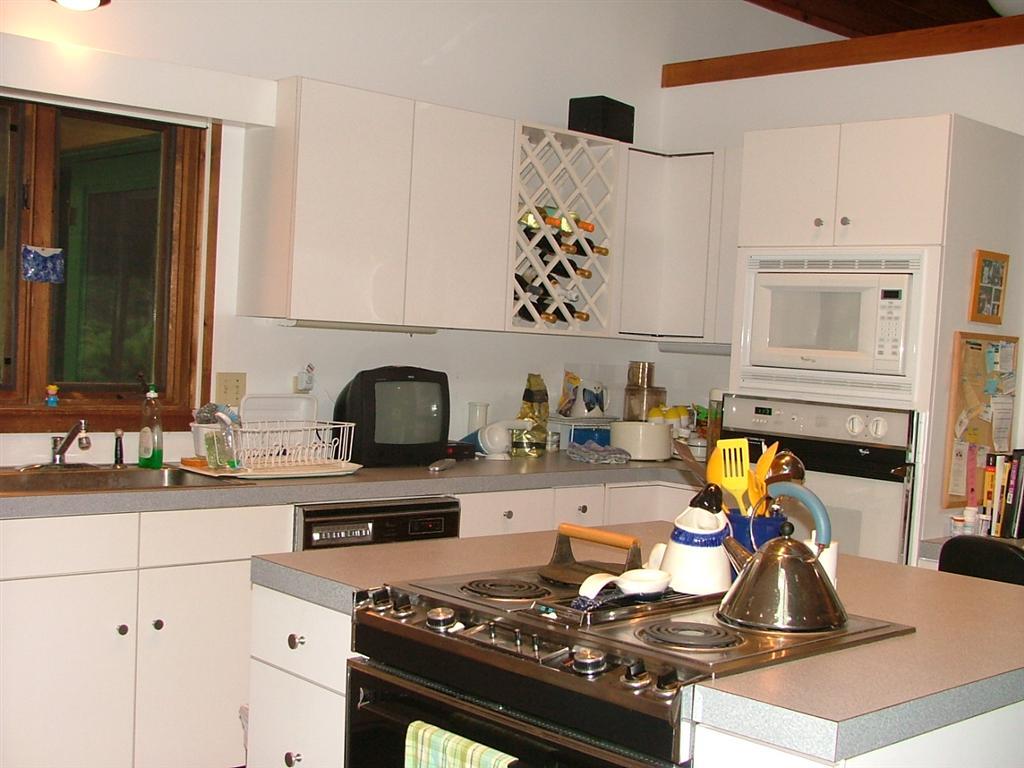 7 Old Tree Farm Road Stockbridge, MA 01266 - Photo 7 of 21 a kitchen with a stove and white cabinets