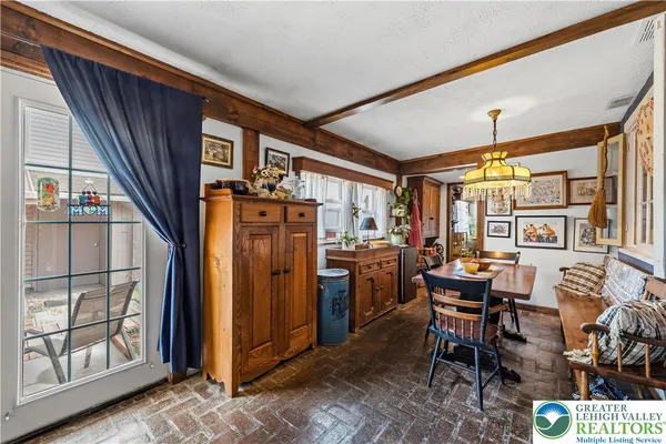 a dining room with furniture and window