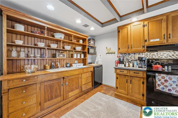 a kitchen with stainless steel appliances granite countertop a stove and cabinets