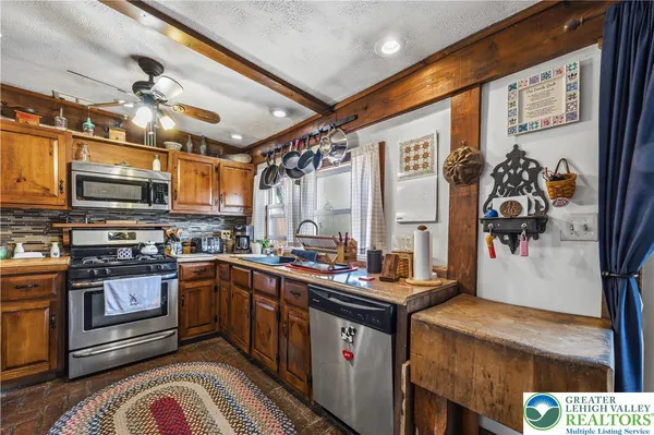 a kitchen with stainless steel appliances granite countertop a sink and cabinets