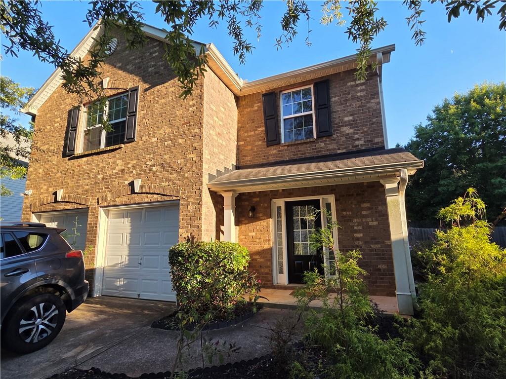 5834 Bridgeport Court Flowery Branch, GA 30542 - Photo 1 of 19 a front view of a house with garden