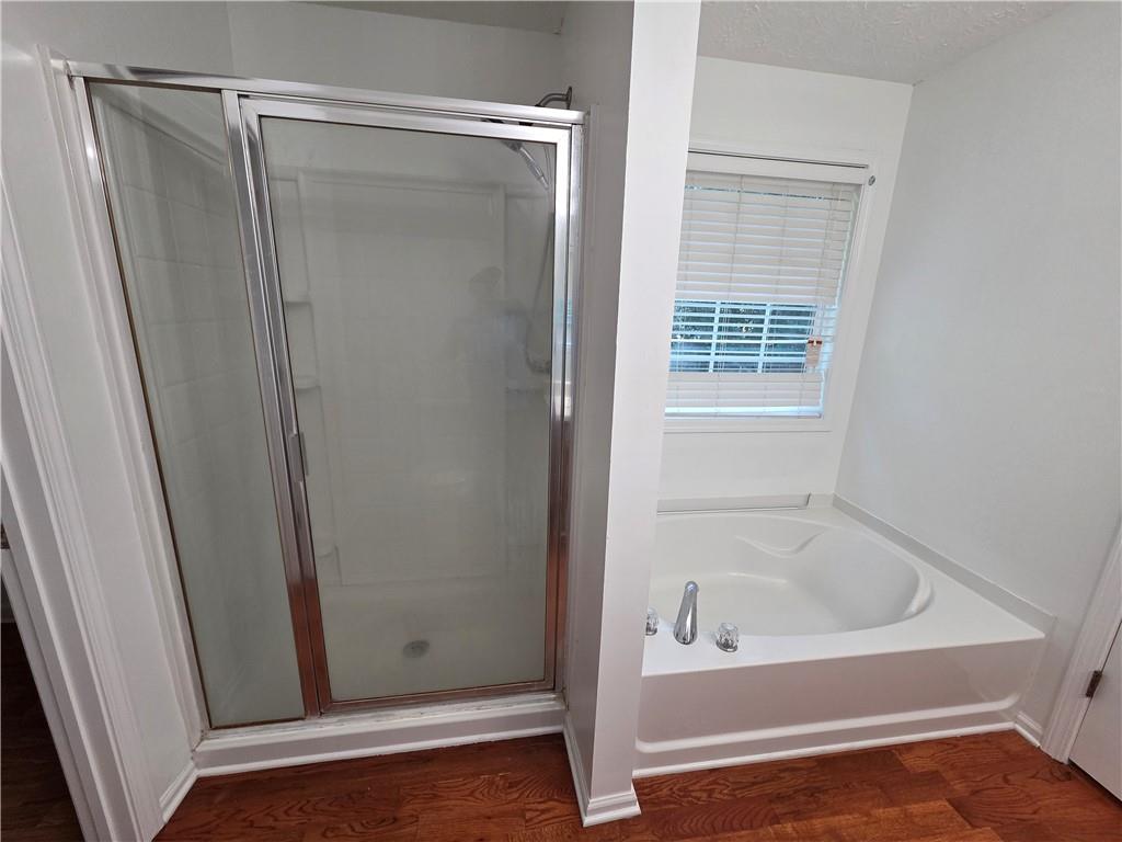 5834 Bridgeport Court Flowery Branch, GA 30542 - Photo 11 of 19 a bathroom with a bathtub and a shower