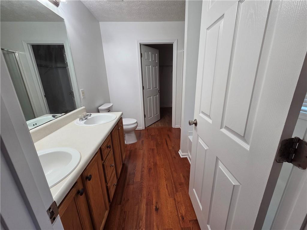 5834 Bridgeport Court Flowery Branch, GA 30542 - Photo 12 of 19 a view of a hallway with wooden floor and staircase