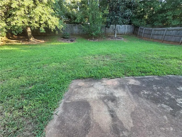 a backyard of a house with lots of green space