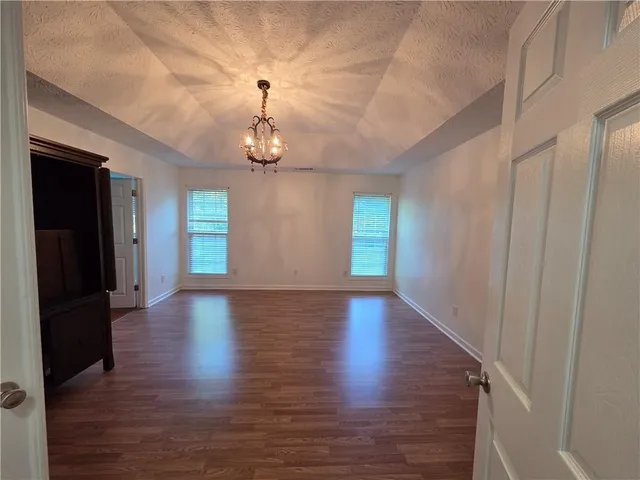 a view of livingroom with hardwood floor and kitchen view