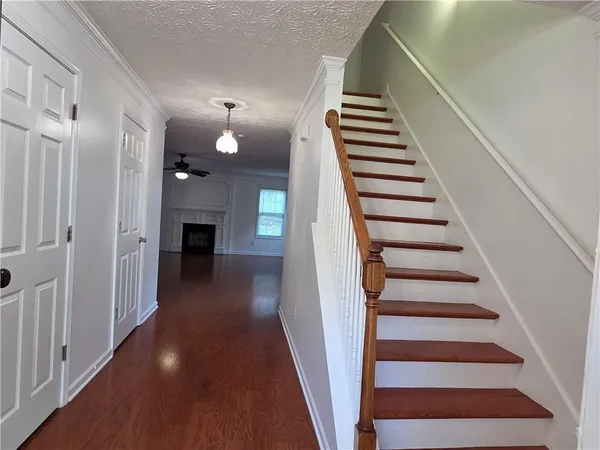 a view of a hallway with wooden floor