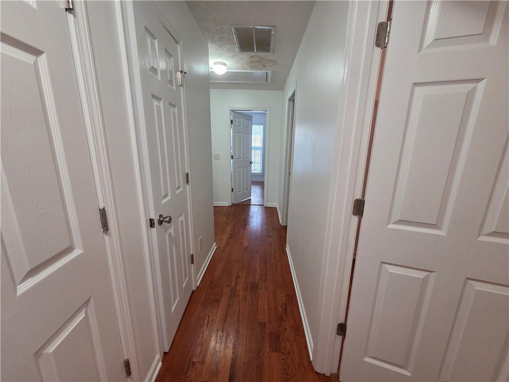 5834 Bridgeport Court Flowery Branch, GA 30542 - Photo 9 of 19 a view of a hallway with wooden floor