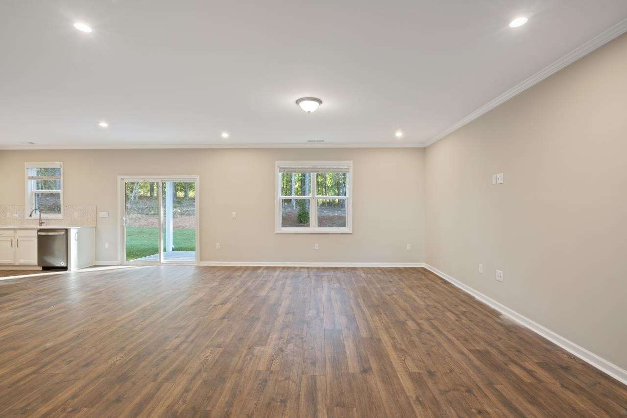267 Madden Rose Loop Garner, NC 27529 - Photo 14 of 41 an empty room with wooden floor and windows