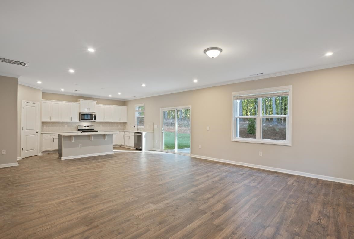 267 Madden Rose Loop Garner, NC 27529 - Photo 16 of 41 a view of kitchen with cabinets and wooden floor