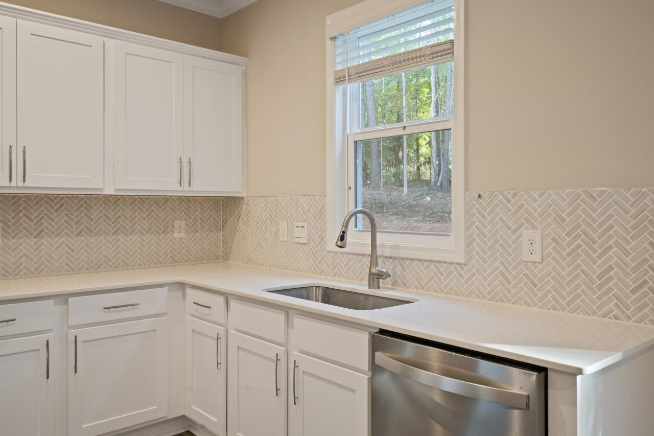 267 Madden Rose Loop Garner, NC 27529 - Photo 25 of 41 a kitchen with a sink cabinets and window