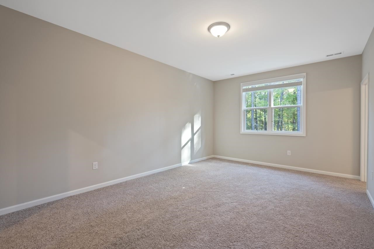 267 Madden Rose Loop Garner, NC 27529 - Photo 29 of 41 an empty room with windows