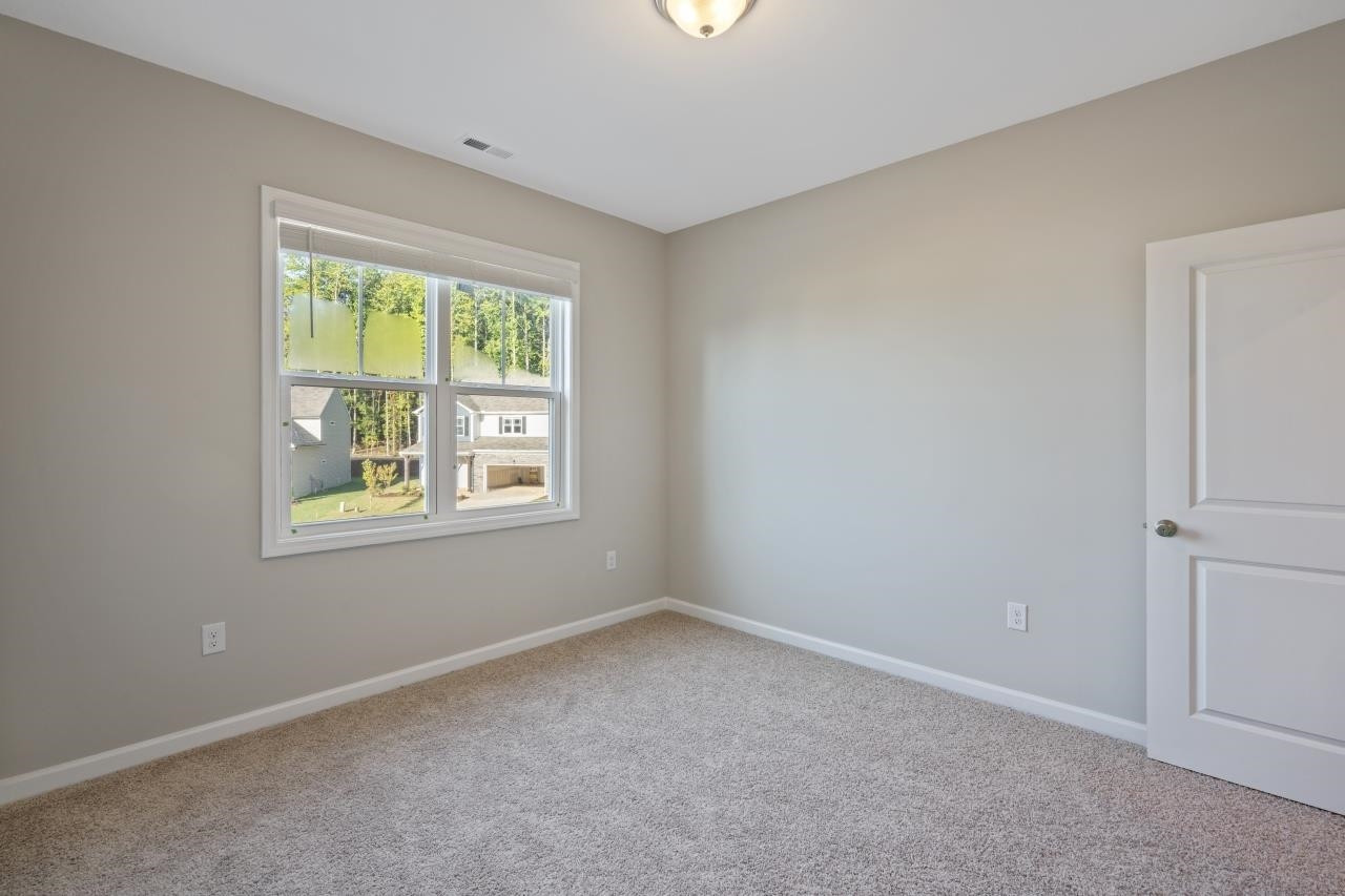 267 Madden Rose Loop Garner, NC 27529 - Photo 35 of 41 an empty room with a window