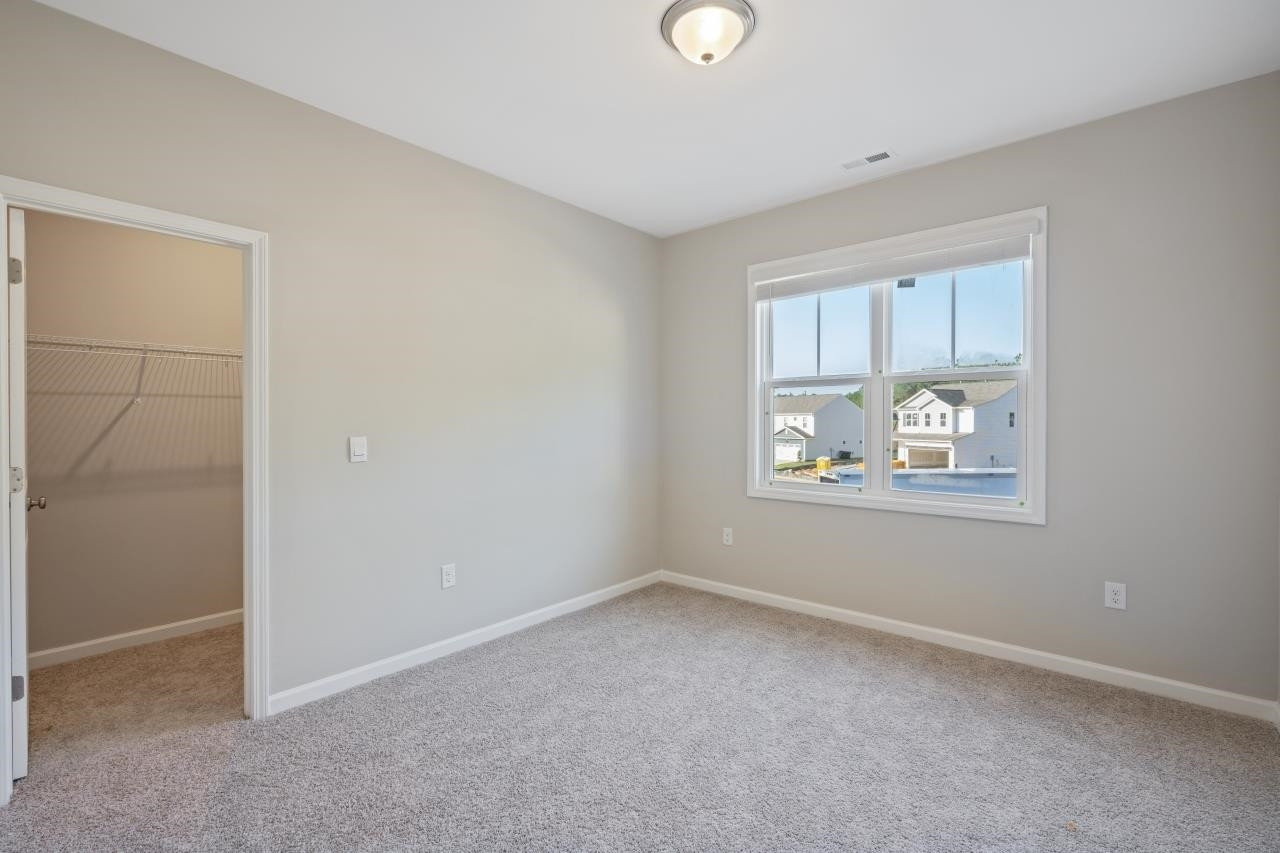 267 Madden Rose Loop Garner, NC 27529 - Photo 37 of 41 an empty room with windows