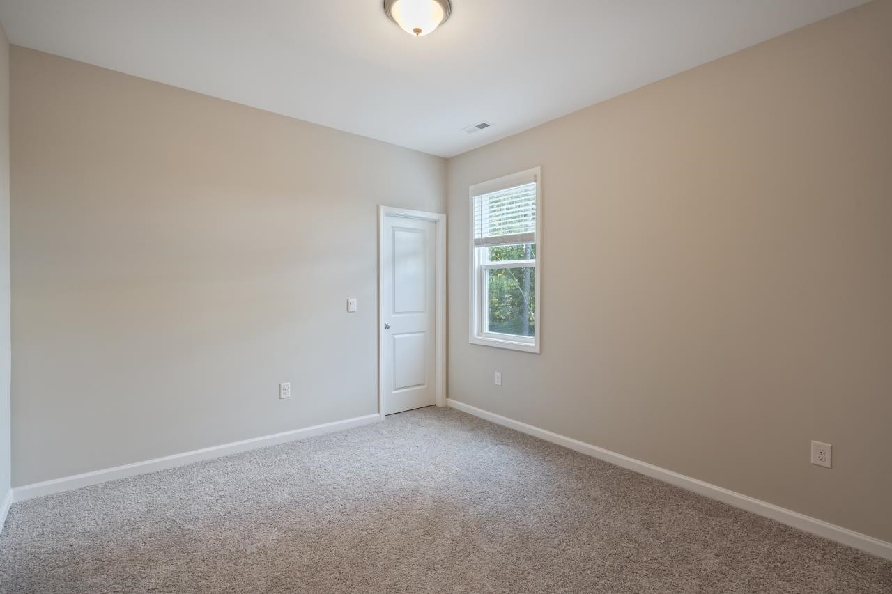267 Madden Rose Loop Garner, NC 27529 - Photo 38 of 41 a view of an empty room with a window