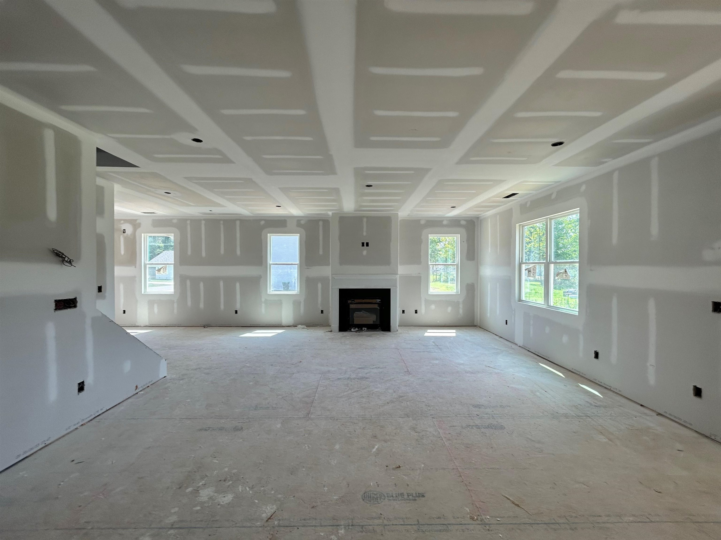 267 Madden Rose Loop Garner, NC 27529 - Photo 6 of 41 a view of an empty room with a fireplace and a window