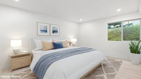 a bedroom with a large bed and a window