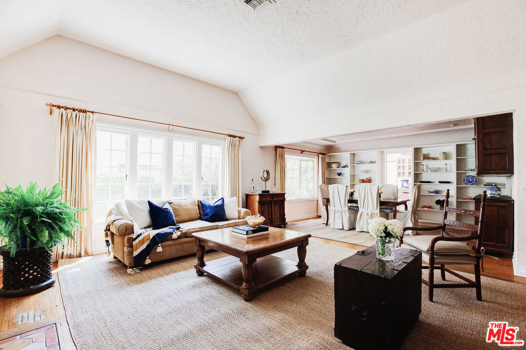 9018 Elevado Avenue West Hollywood, CA 90069 - Photo 1 of 32 a living room with furniture and a flat screen tv
