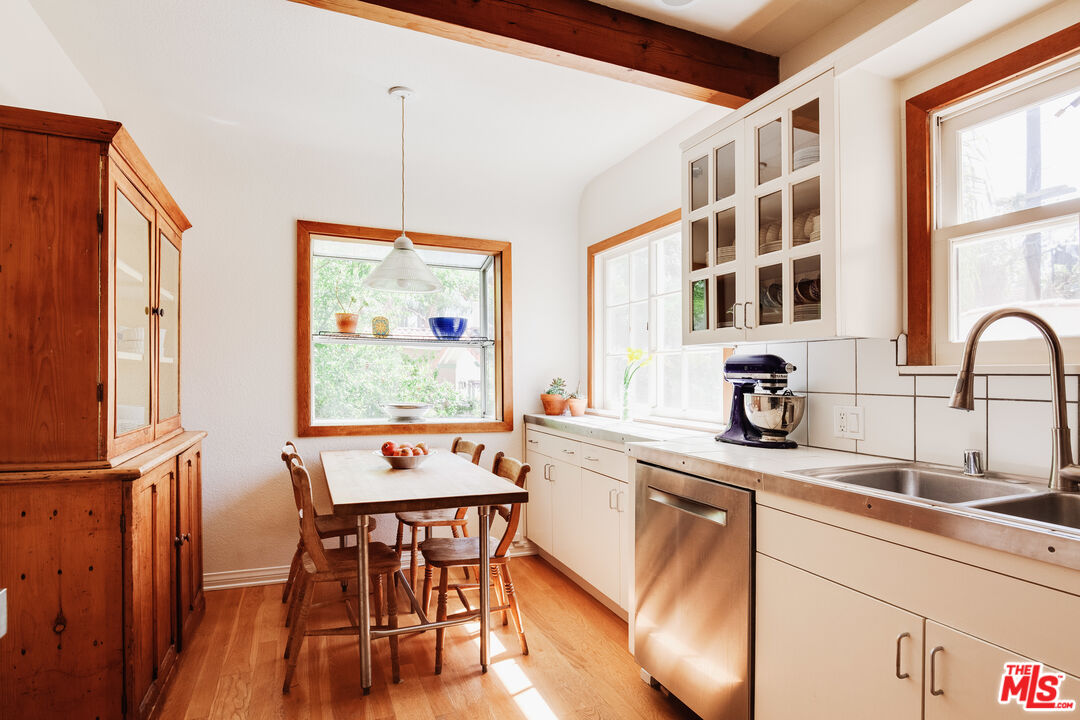 9018 Elevado Avenue West Hollywood, CA 90069 - Photo 12 of 32 a kitchen with a dining table chairs and refrigerator