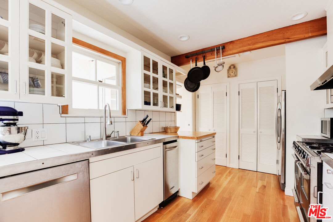 9018 Elevado Avenue West Hollywood, CA 90069 - Photo 14 of 32 a kitchen with a sink stove and cabinets