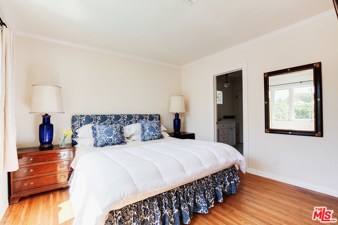 9018 Elevado Avenue West Hollywood, CA 90069 - Photo 17 of 32 a bedroom with a bed and a wooden floor