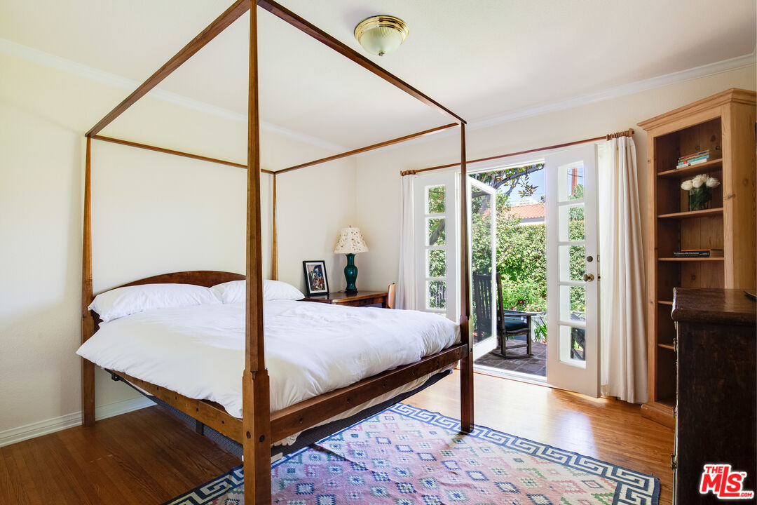 9018 Elevado Avenue West Hollywood, CA 90069 - Photo 20 of 32 a bedroom with a bed and a dresser with wooden floor