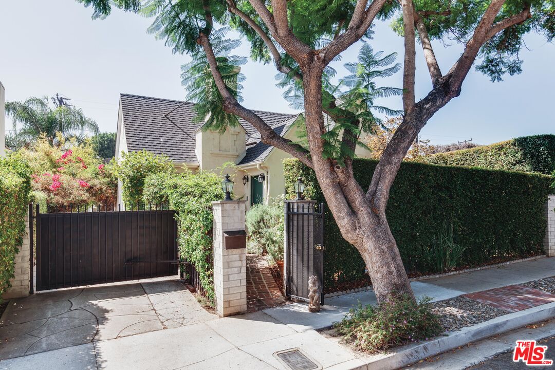 9018 Elevado Avenue West Hollywood, CA 90069 - Photo 2 of 32 a front view of a house with a garden
